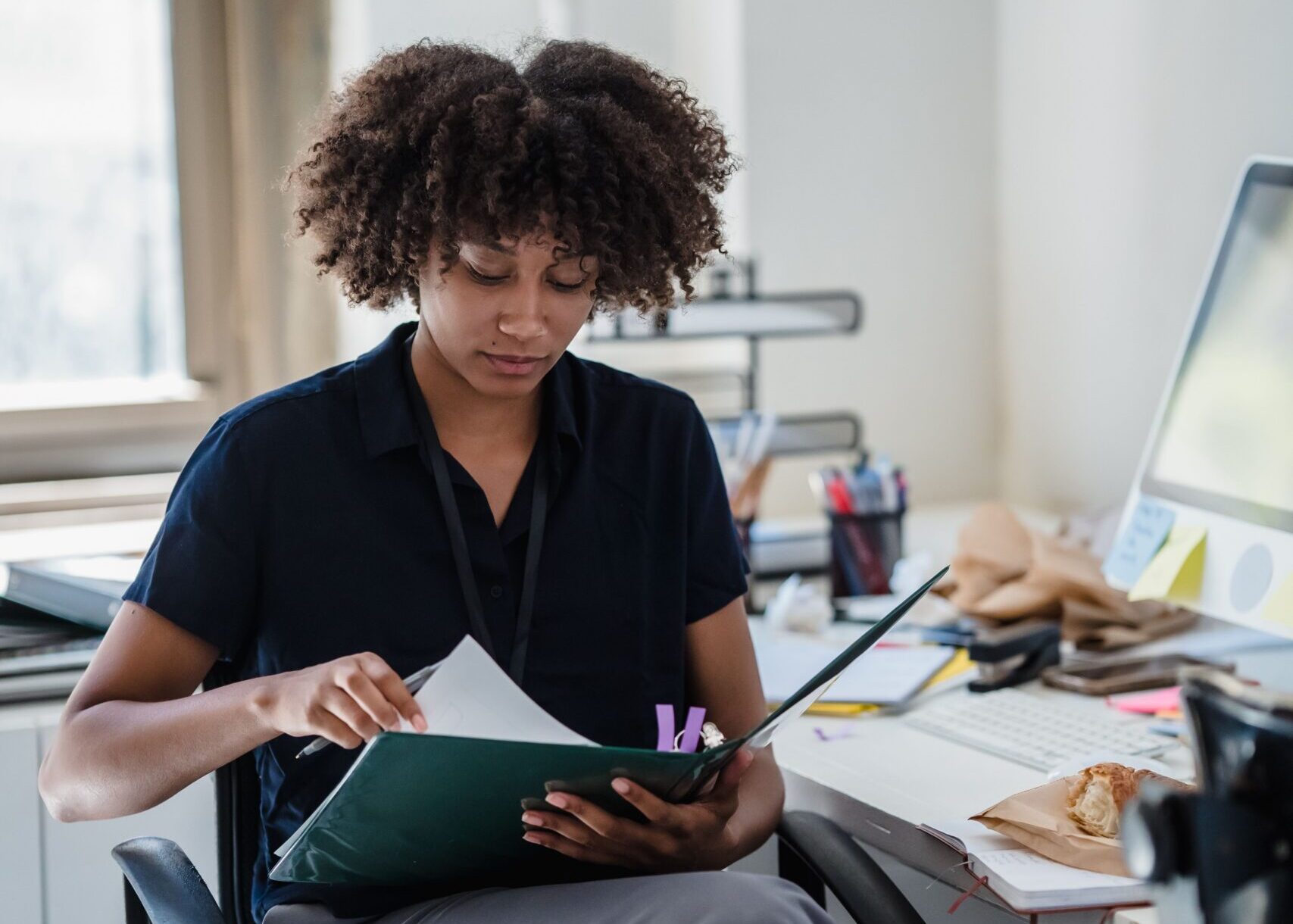 HR manager looking through printed workplace policies
