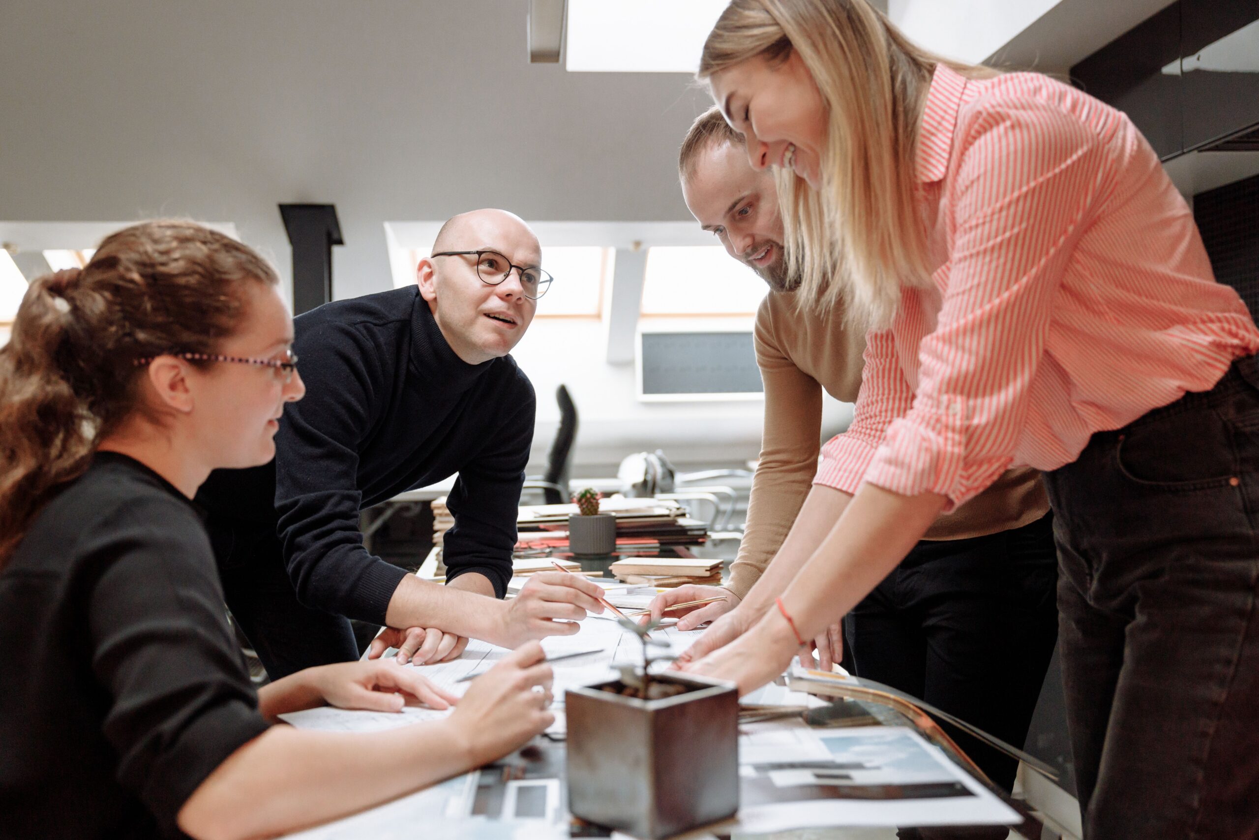 Open workplace policy manual on a boardroom table during a review meeting